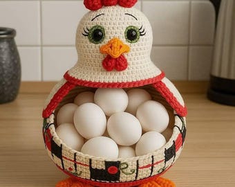 May include: A handcrafted crochet chicken-shaped egg basket. The basket is cream-colored with red and black accents, holding several white eggs. The chicken has a red comb, orange beak, and green eyes. The basket is sitting on a wooden surface.