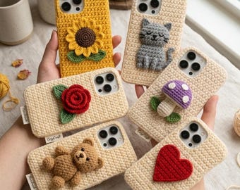 May include: A collection of handmade crochet phone cases in various colors and designs. The cases feature a sunflower, cat, rose, mushroom, teddy bear, and heart. Each case is a unique, textured accessory.