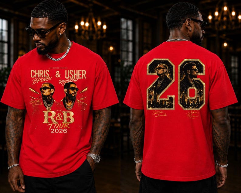 May include: A red short-sleeve t-shirt featuring a graphic print of Chris Brown and Usher with the text 'The R&B Tour 2026' on the front. The back displays the number '26' filled with portraits of the artists and a city skyline silhouette.
