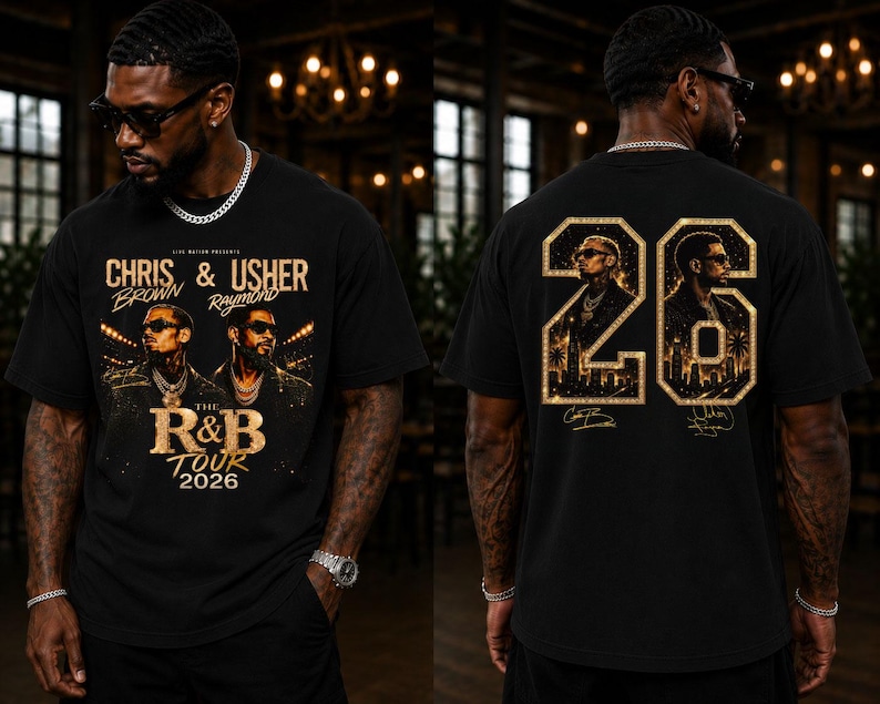May include: A black t-shirt featuring a graphic print of Chris Brown and Usher. The front displays the text "Chris & Usher", "The R&B Tour 2026". The back features a large gold "26" with portraits of the artists and city silhouettes inside.