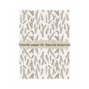 Könnte beinhalten: Ein weißes Transferpapier mit einem schwarz-weißen botanischen Muster aus Blättern. Der Text "Transfer paper 01- Neutral botanical" ist auf das Papier gedruckt.