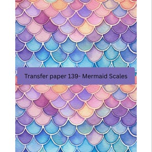 May include: Watercolor design of mermaid scales in shades of purple, blue, pink, and orange. The scales are arranged in a repeating pattern. The text "Transfer paper 139- Mermaid Scales" is displayed on a purple banner.