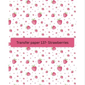 May include: White background with a repeating pattern of pink strawberries and small pink dots. The strawberries have green stems. A pink rectangle at the bottom reads "Transfer paper 137- Strawberries".