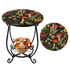 May include: A round side table with a black metal frame and a floral and mushroom design on the tabletop. The table has a lower shelf with a woven basket filled with colorful flowers. The tabletop design includes red mushrooms, yellow flowers, and green leaves.