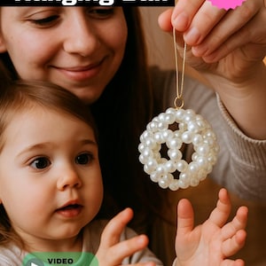 May include: A decorative hanging ball made of white beads. The image shows a person holding the ornament, with a child in the foreground. The text "BEADED Hanging Ball" is at the top, and a "50% OFF" pink sticker is in the upper right corner. A video tutorial is available.