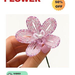 May include: A handmade beaded flower in shades of pink and white, with a pearl center. The flower is held by a hand. The word "BEADED" is above the word "FLOWER" in red. A yellow sticker says "50% OFF". A video tutorial is available.