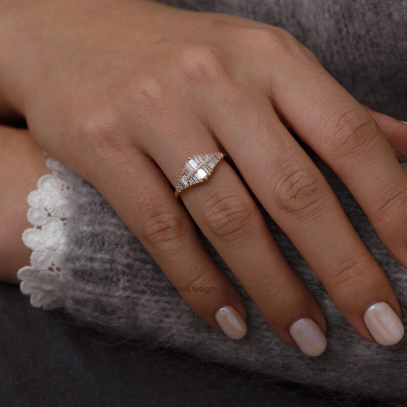18k gold art deco baguette diamond ring with geometric tapered design on white background