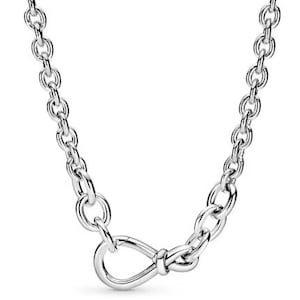 May include: A silver chain necklace with a knotted infinity symbol pendant.