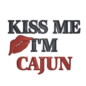 May include: Embroidered design with the text "Kiss Me I'm Cajun" in black and red. A red lip print is next to the text "I'm".