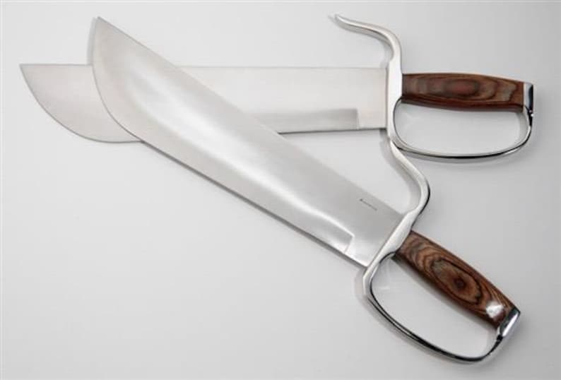 May include: A pair of silver-coloured double-edged swords with wooden handles. The swords have a curved guard and a sharp point.
