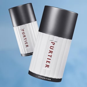 May include: A white ceramic mug with a black handle and the text "But First, Coffee" in a black, handwritten-style font. The mug is on a white surface.