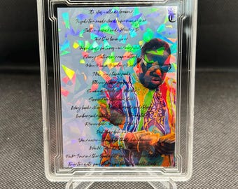 May include: A holographic trading card featuring a portrait of a man with a colorful background. The card has the text "It Was All A Dream" and "The Notorious B.I.G." printed on it.