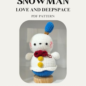 May include: A crocheted snowman with a blue hat and base, a red bow, and yellow buttons. The text "HAPPY SNOWMAN LOVE AND DEEPSPACE PDF PATTERN" is at the top. The image also includes text about the pattern's usage.