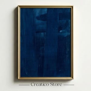 May include: Abstract art print in a gold frame. The artwork features a deep blue colour palette with vertical brushstrokes. The frame is a warm gold tone, and the print is displayed against a white wall. The text "Creatico Store" is at the bottom.
