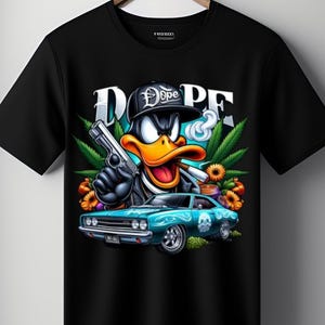 May include: Black t-shirt with a cartoon duck wearing a cap that says "Dope" and holding a gun and a lit cigarette. The graphic includes a teal car, cannabis leaves, and the word "DOPE" in large letters.