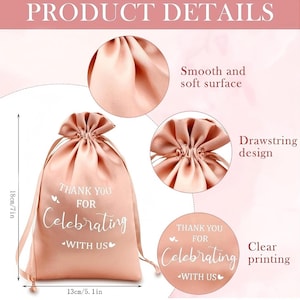May include: A blush pink satin drawstring bag with the text "THANK YOU FOR Celebrating WITH US" in white script. The bag is 18cm tall and 13cm wide. Features include a smooth surface and clear printing.