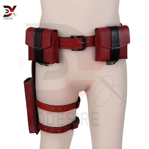 May include: Red and black leather belt with two pouches on the front and a thigh holster on the left leg.