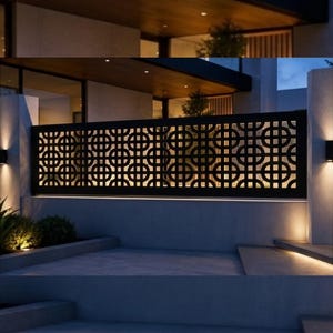 May include: A black metal privacy screen featuring a repeating geometric pattern of intersecting circles and squares. The rectangular panel is mounted between two concrete pillars and is illuminated from below by integrated lighting.