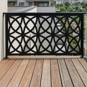 May include: A black metal balcony railing featuring a repeating geometric pattern of intersecting circles. The railing is mounted on a wooden deck with horizontal planks, providing a clear view of the outdoor space beyond the structure.