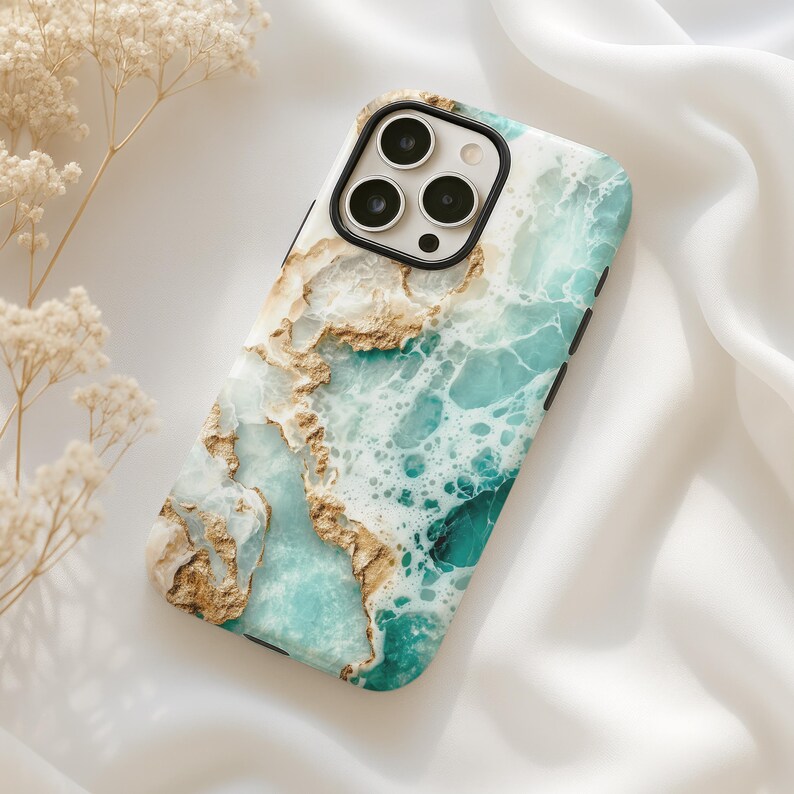 May include: A phone case with a marble design featuring shades of blue, green, and gold. The case has a cutout for the camera lens.