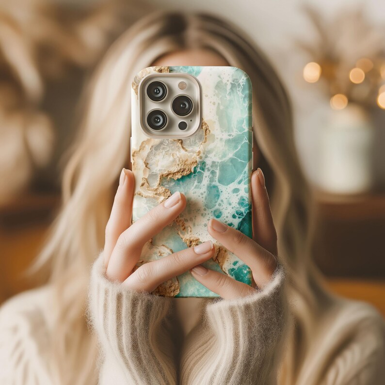 May include: A phone case with a blue and gold marble design. The case has a raised camera bump with three lenses.