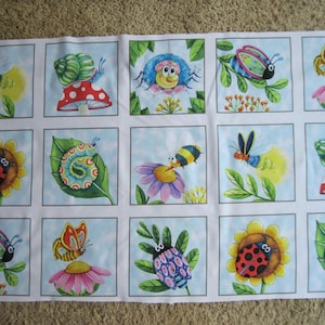May include: A fabric panel featuring a grid of fifteen square illustrations of colorful cartoon insects and garden elements, including ladybugs on sunflowers, snails on mushrooms, caterpillars on leaves, bees on flowers, and butterflies.