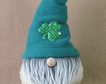 May include: A green felt gnome with a white beard and a green shamrock made of sequins on its hat.