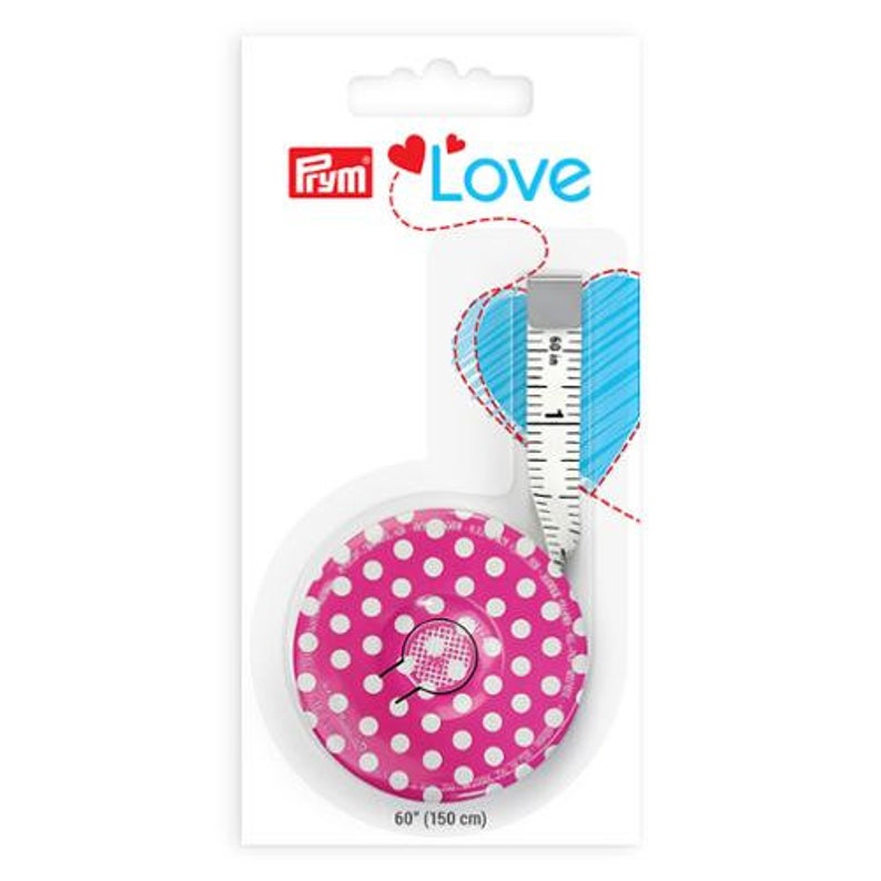 May include: A pink and white polka dot measuring tape with a retractable tape measure. The tape measure is 60 inches (150 cm) long. The packaging has the word "Love" and the Prym logo.