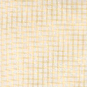 May include: Close-up of a fabric with a yellow and white plaid pattern. The grid-like design features thin yellow lines intersecting on a white background, creating a classic, textured look. The fabric appears to be cotton or a similar material.