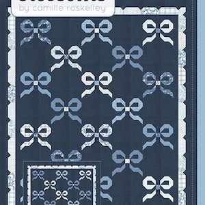 May include: A navy blue quilt pattern featuring repeating bow designs in shades of blue and white. The quilt has a white scalloped border and includes the text "thimble blossoms" and "DARLING".