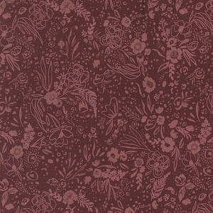 May include: A close-up of a burgundy fabric with a floral pattern. The design features various flowers, leaves, and small dots in a lighter shade of burgundy. The overall effect is a dense, detailed botanical print.