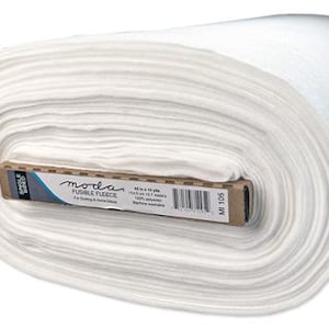 May include: A large roll of white Moda fusible fleece fabric. The fabric is rolled tightly and has a soft, textured appearance. The label indicates the fabric is 60 inches by 10 yards, made of 100% polyester, and machine washable. Ideal for quilting and home decor.