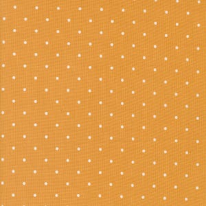 May include: A fabric with a yellow background and a white polka dot pattern.