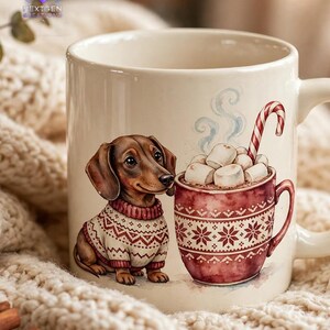 May include: A cream-colored ceramic mug featuring a brown dachshund wearing a white and red patterned sweater. Next to the dog is a smaller red mug filled with marshmallows and a candy cane. The mug has a handle and a smooth finish.