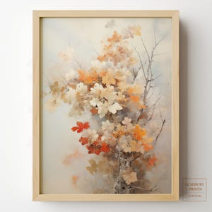 Pode incluir: Uma impressão de arte emoldurada com uma pintura em aquarela de folhas de outono em tons de laranja, branco e vermelho. As folhas estão agrupadas em galhos contra um fundo suave e neutro. A moldura é de madeira clara.