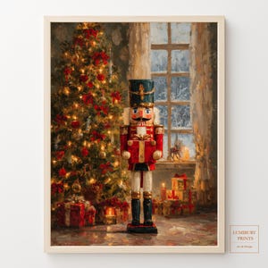 May include: A framed wall art print featuring a nutcracker figure in a red uniform holding a gift, standing before a decorated Christmas tree with glowing lights and wrapped presents, set against a window view of a snowy winter landscape.