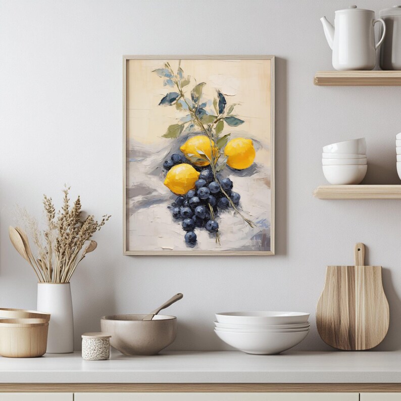 Lemons and blueberries are arranged in a casual yet artful still life with a soft, naturalistic brushstroke. The muted backdrop and delicate leafy branch evoke a calm and earthy feeling. This piece brings a touch of countryside freshness to any modern or rustic kitchen wall.