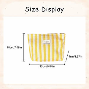 May include: A yellow and white striped cosmetic bag with the text "Size Display". The bag is 18cm/7.08in high, 25cm/9.84in wide, and 4cm/1.57in deep. A small label is sewn on the front.