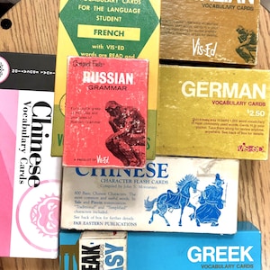 May include: A collection of vintage language learning vocabulary cards. The cards feature various languages including French, Italian, German, Russian, Greek, and Chinese. The cards are colorful and have a retro design.