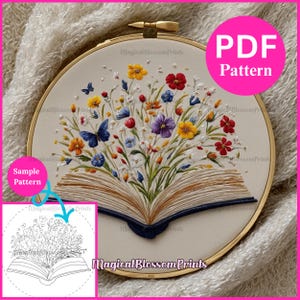 May include: An embroidery hoop featuring a colorful floral design emerging from an open book. The design includes butterflies and various flowers in shades of yellow, red, blue, and purple. The text "PDF Pattern" is visible. The text "Magical Blossom Prints" is also visible.