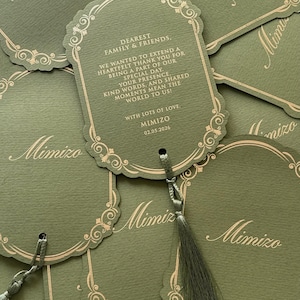 May include: Olive green gift tags with gold decorative borders and tassels. The tags have the word "Mimizo" printed on them, along with a message that reads "Dearest Family & Friends, We wanted to extend a heartfelt thank you..."