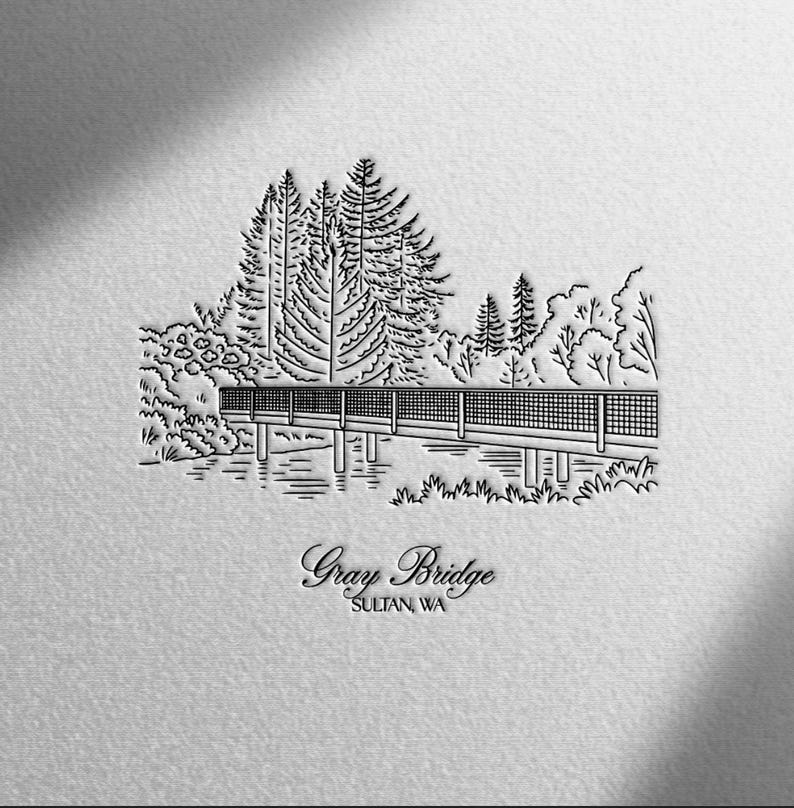 May include: A black and white line drawing of a bridge over water, with trees in the background. The text "Gray Bridge" and "Sultan, WA" is below the bridge.