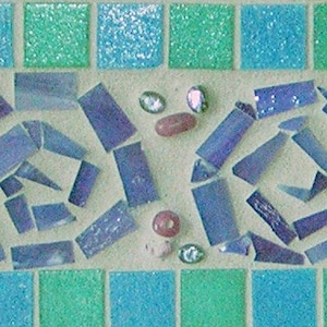 May include: A mosaic tile border with a repeating pattern of blue and green tiles. The border features a design of four blue swirls made of smaller blue tiles.