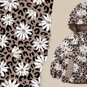 Könnte beinhalten: Eine braune Kapuzenjacke mit einem Muster aus weißen Gänseblümchen und Leopardenmuster.