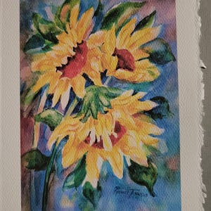 May include: Watercolor painting of three yellow sunflowers with red centers against a blue background.