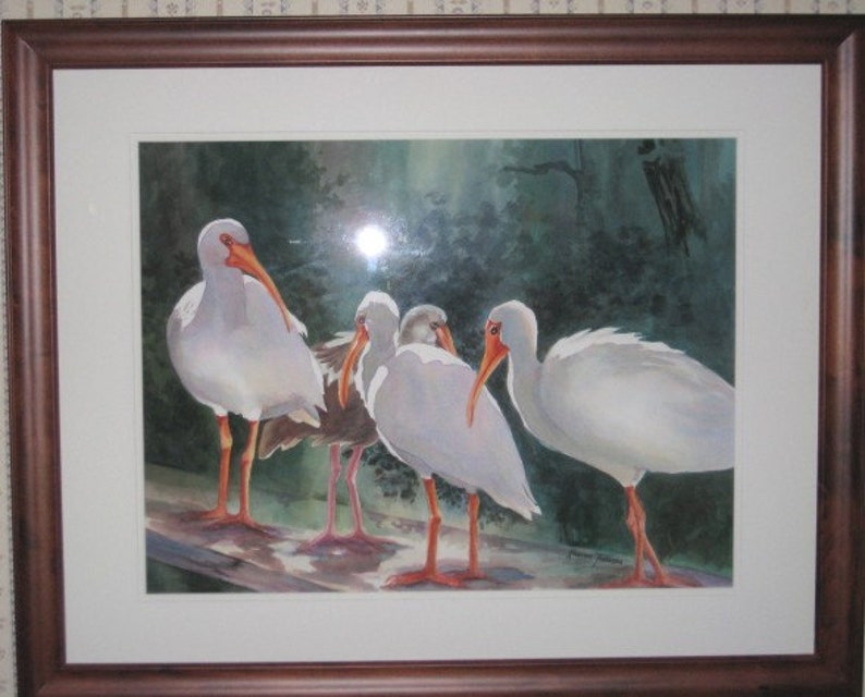 May include: A watercolor painting of four white birds with orange beaks standing on a wooden surface. The birds are in a forest setting with green foliage and a blue sky in the background.