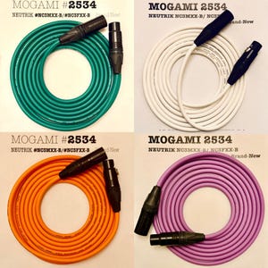 May include: Four coiled Mogami 2534 audio cables with Neutrik connectors. The cables are in green, white, orange, and purple. The text "MOGAMI #2534" and "NEUTRIK #NC3MXX-B/#NC3FXX-B" are visible.