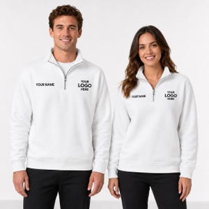 May include: Two white quarter-zip sweatshirts featuring a silver zipper at the collar. Each garment displays the black printed text YOUR NAME on the right chest and YOUR LOGO HERE on the left chest, providing a customizable design for branding.