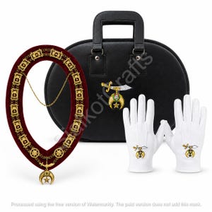 May include: A ceremonial collar featuring a deep red velvet band with gold-toned metal links, a central crescent and star pendant, and a matching sword emblem. Includes a black carrying case and a pair of white gloves with embroidered emblems.
