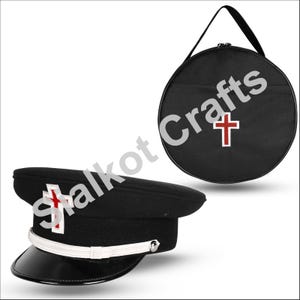 May include: Black military-style hat with a white cross and red accents, a white band, and a black visor. A black round carrying case with a red cross is also shown.